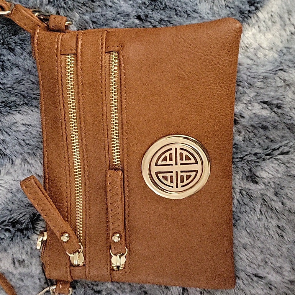 Tan color crossbody purse with lots of pockets.